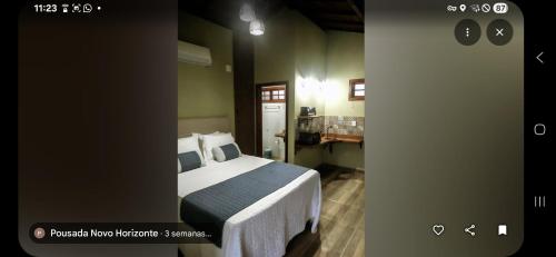a bedroom with a bed and a sink in a room at Chalés Novo Horizonte in Natividade do Carangola