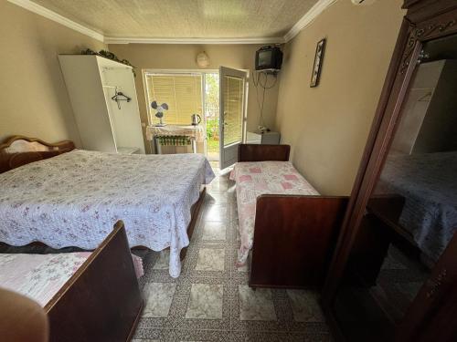 a bedroom with two beds and a mirror in it at Kobuleti Central in K'obulet'i