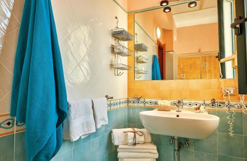 a bathroom with a sink and a mirror at Hotel La Pergola in Santa Maria di Castellabate