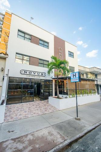 a building on a street with a sign in front of it at Novus Laureles in Medellín