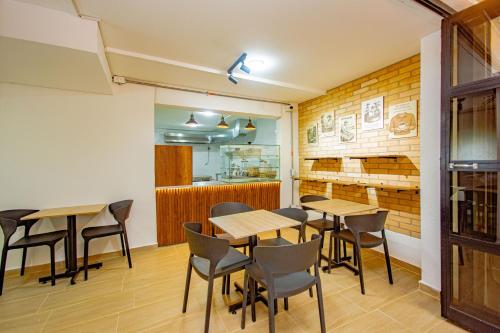 a room with tables and chairs in a restaurant at Novus Laureles in Medellín