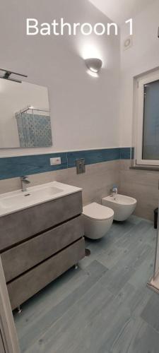 a bathroom with two sinks and a toilet at Cielo e Mare in Positano
