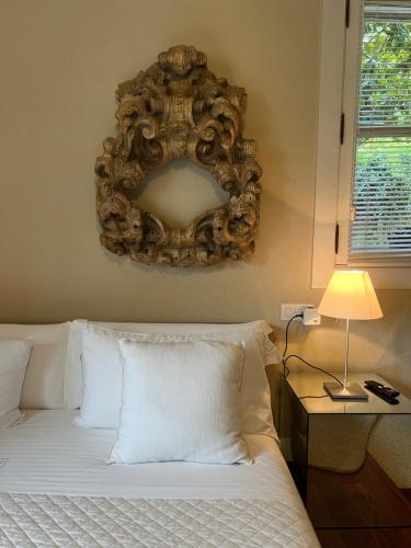 a bedroom with a bed with a mirror on the wall at Enoturismo Novavila Rias Baixas Wine Design in Meis