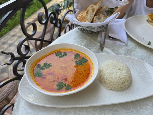a bowl of soup and a bowl of rice on a table at L'Argamak in Samarkand