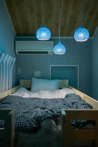 a bedroom with a bed with blue lights above it at Skytree View Rooftop Villa Asakusa SVRVA in Tokyo