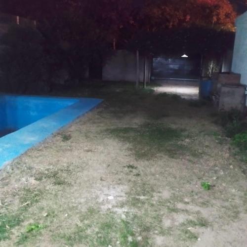an empty backyard with a swimming pool at night at Casa en alquiler por día en La Rioja in La Rioja