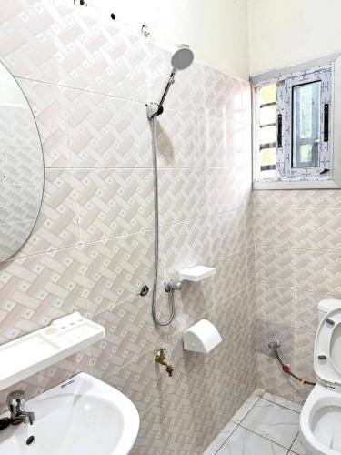 a bathroom with a shower and a sink and a toilet at Charming apartment in Yaoundé - Nkolmesseng in Yaoundé