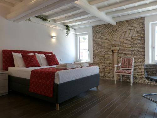a bedroom with a large bed and a brick wall at The little column in Rome