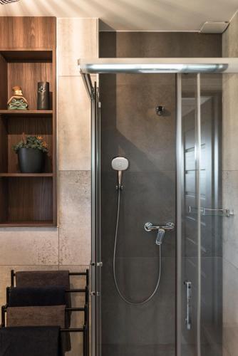 a shower with a glass door in a bathroom at Szatki Karkonoskie in Bukowiec