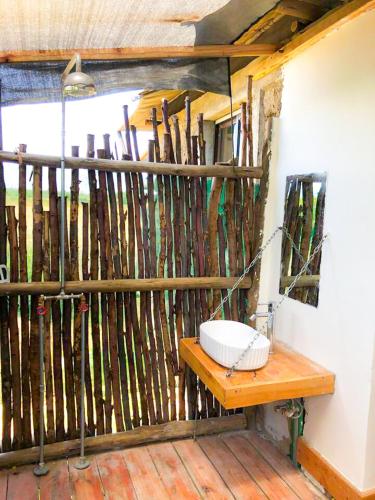 a wooden fence with a sink in a room at Ole-lekurruki Naromoru Cabins in Naro Moru