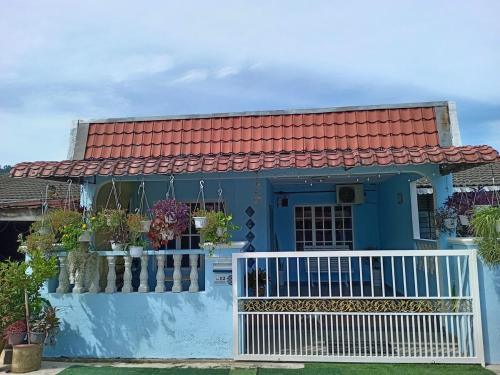 a blue house with a red roof at Salza Homestay in Hulu Langat