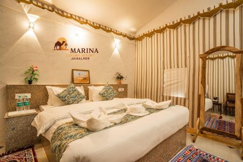 a bedroom with a large bed in a room at Marina Luxery resort Jaisalmer in Jaisalmer
