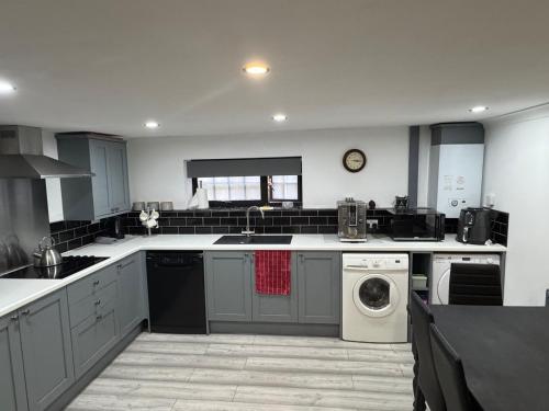 a large kitchen with a washer and dryer in it at The workshop in Kings Lynn