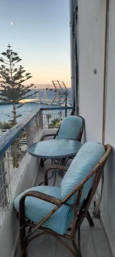 a couple of chairs and a table on a balcony at Selena Rooms in Agia Galini