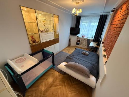 a small room with a bed and a window at BaSoTo in Sopot
