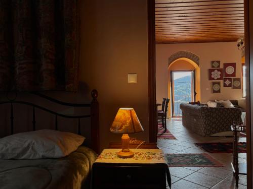 a bedroom with a bed and a lamp on a table at Sophia's Stone House in Dhimitsana