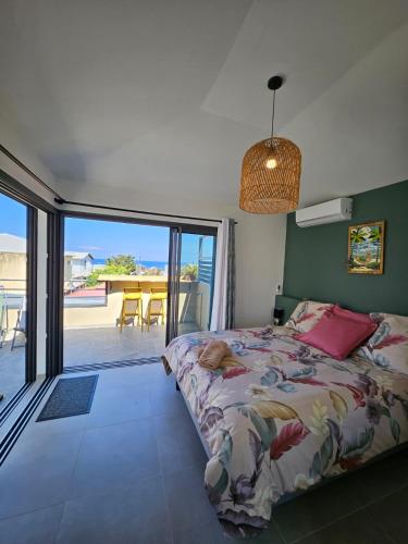 a bedroom with a bed and a view of the ocean at joly brise in Saint-Pierre
