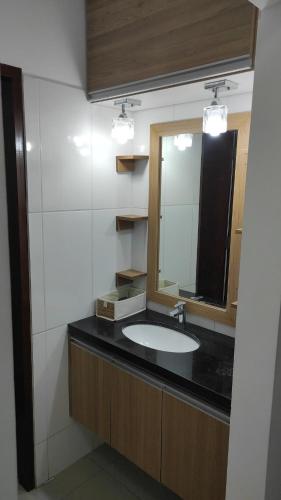 a bathroom with a sink and a mirror at Comfortable and Elegant Apartment, in Santa Cruz de la Sierra