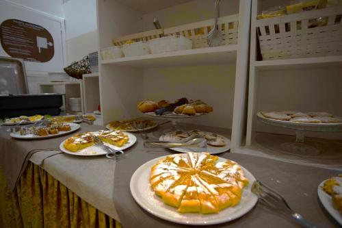 a table with plates of food on it at Hotel Sant'Elena in Rimini