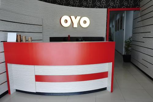 an ovo store with a red and white front at Hotel O Bukittinggi near Jam Gadang formerly Hotel Aedo in Bukittinggi