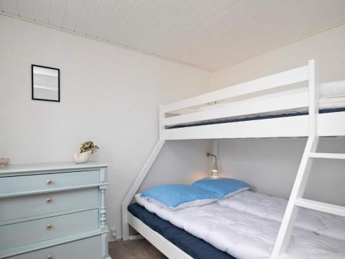 a bedroom with a bunk bed and a ladder at 16 person holiday home in Nykøbing M in Jørsby