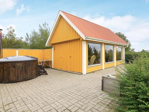 a large yellow building with a hot tub next to it at 16 person holiday home in Nykøbing M in Jørsby