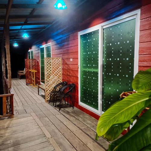 a room with a large window on a deck at TA YAI HOMESTAY (ตา ยาย โฮมสเตย์) in Ko Kood