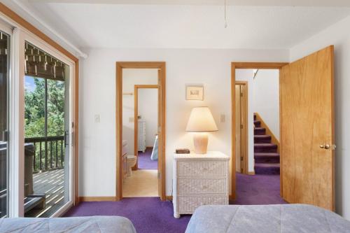 a bedroom with a bed and a balcony at 8455 - Mad Hatteras in Avon