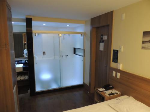 a bathroom with a glass shower in a hotel room at Samba Rio 1900 in Rio de Janeiro