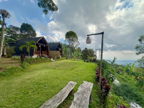 a yard with a bench and a house at Munduk Harum Glamping in Munduk
