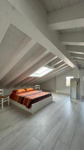 a bedroom with a bed in a large room at La Casa di Nives in Scorzè