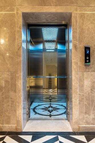 a elevator in a building with a glass door at PINNACLE Udaipur - Boutique Rooftop Pool Hotel, Near the Lakes in Udaipur