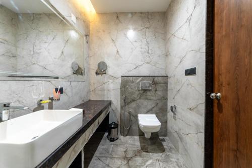 a bathroom with a sink and a toilet at PINNACLE Udaipur - Boutique Rooftop Pool Hotel, Near the Lakes in Udaipur