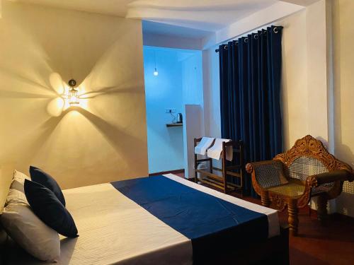 a bedroom with a bed with a light on the wall at Ella Hidden Ferns in Ella