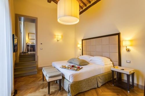 a bedroom with a large bed with a tray of food on it at Castello La Leccia in Castellina in Chianti