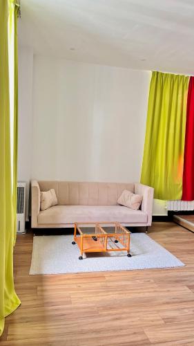 a living room with a couch and a coffee table at Hôtel de la paix in Limoges