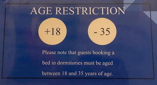 a sign that says age restriction on a case at Minerva Rooms in Rome