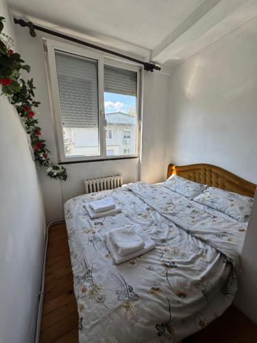 a bedroom with a bed with two towels on it at Klina Apartment in Skopje