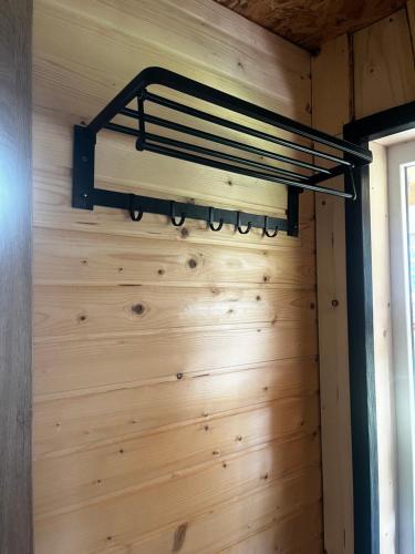 a room with a wooden wall with a shelf on it at Горизонт in Iltsi