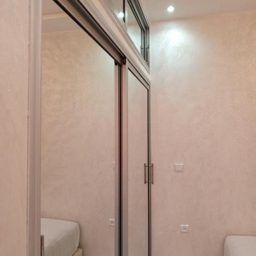 a glass shower door in a bathroom next to a stair at Riad Bollywood- Prince's Suite in Benguerir