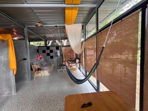 a hammock in the living room of a house at Unplugged Universe for Remote Living in Hinkong