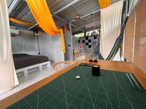 a room with a table with a golf ball on it at Unplugged Universe for Remote Living in Hinkong