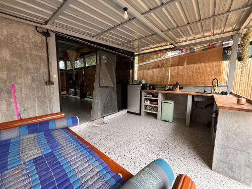 an outdoor room with a kitchen and a sink at Unplugged Universe for Remote Living in Hinkong