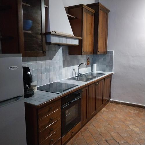 a kitchen with a sink and a refrigerator at Villa Tiberini - Wine Relais in Torrita di Siena