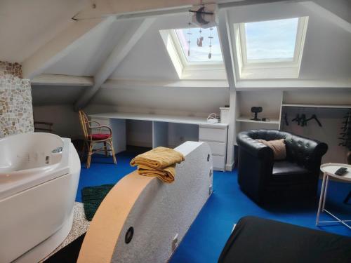 a attic room with a sink and a bath tub at Chambre Suite Zen Baignoire sous les toits in Bénesse-Maremne