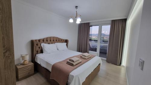 a bedroom with a bed with two towels on it at Riverside Panorama in Kŭrdzhali
