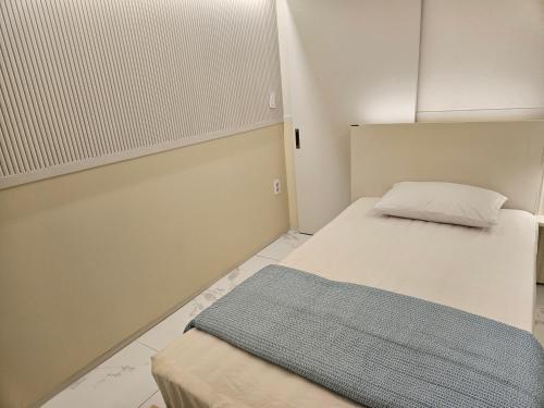 a small room with a bed and a pillow at Daegu Star B&B DSR Hotel lily in Daegu