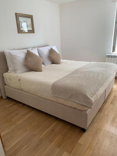 a bedroom with a bed with white sheets and pillows at Deluxe Apartment Dora with a private parking, terrace and see view in Rijeka