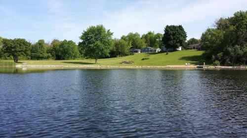 a large body of water with a house in the background at Secluded Lake Retreat - Private Beach, Pier & Fire Pit in Ingleside