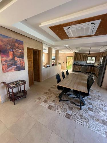 a living room with a wooden table and chairs at Villa Dar Hamza Marrakech in Tahannout